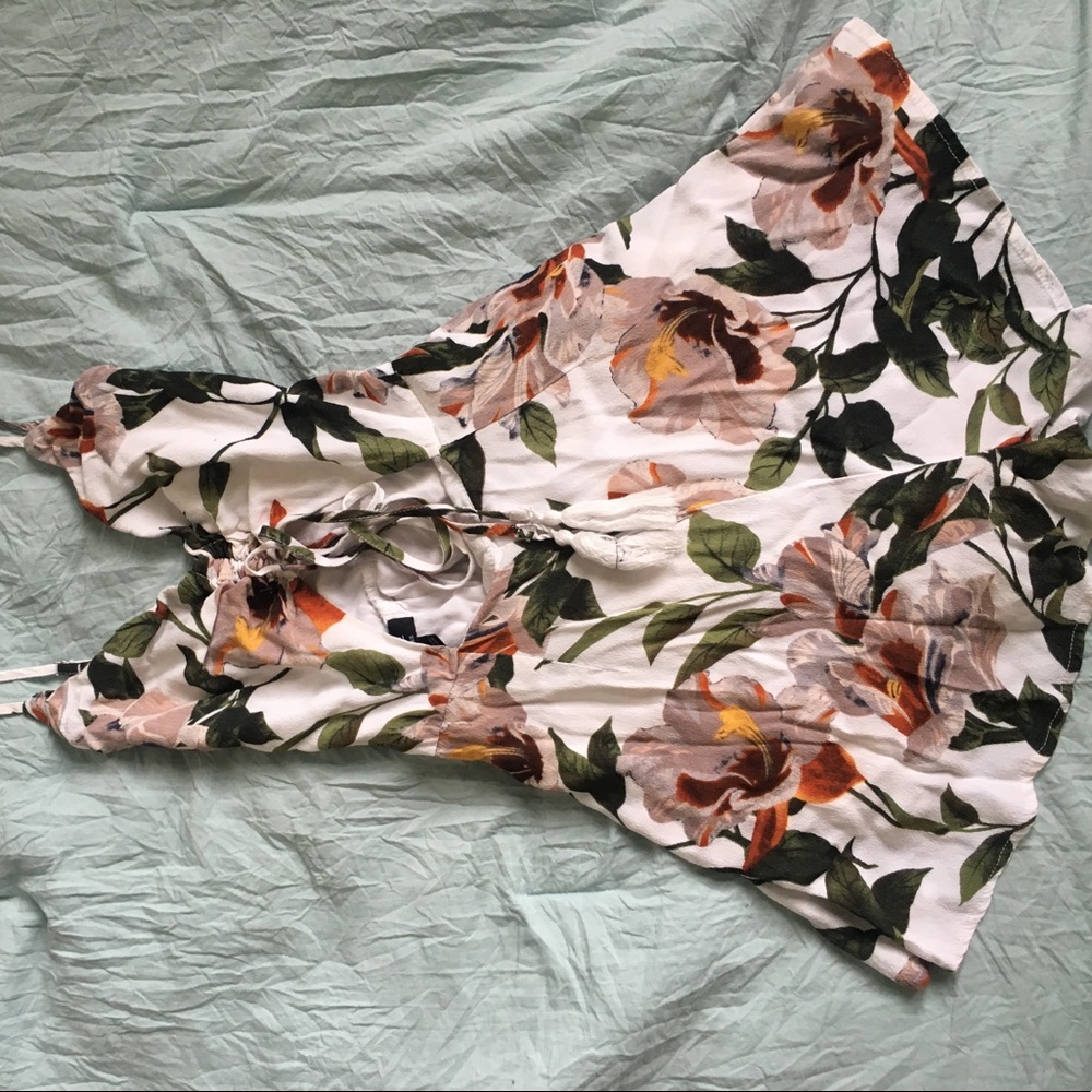 Floral romper, lined with ties at front.